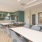 spacious lounge room with ample seating and modern colors and decor with bright-natural lighting